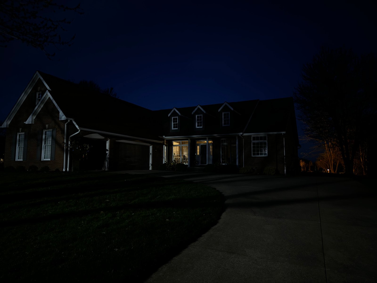 Home exterior at night before landscape lighting