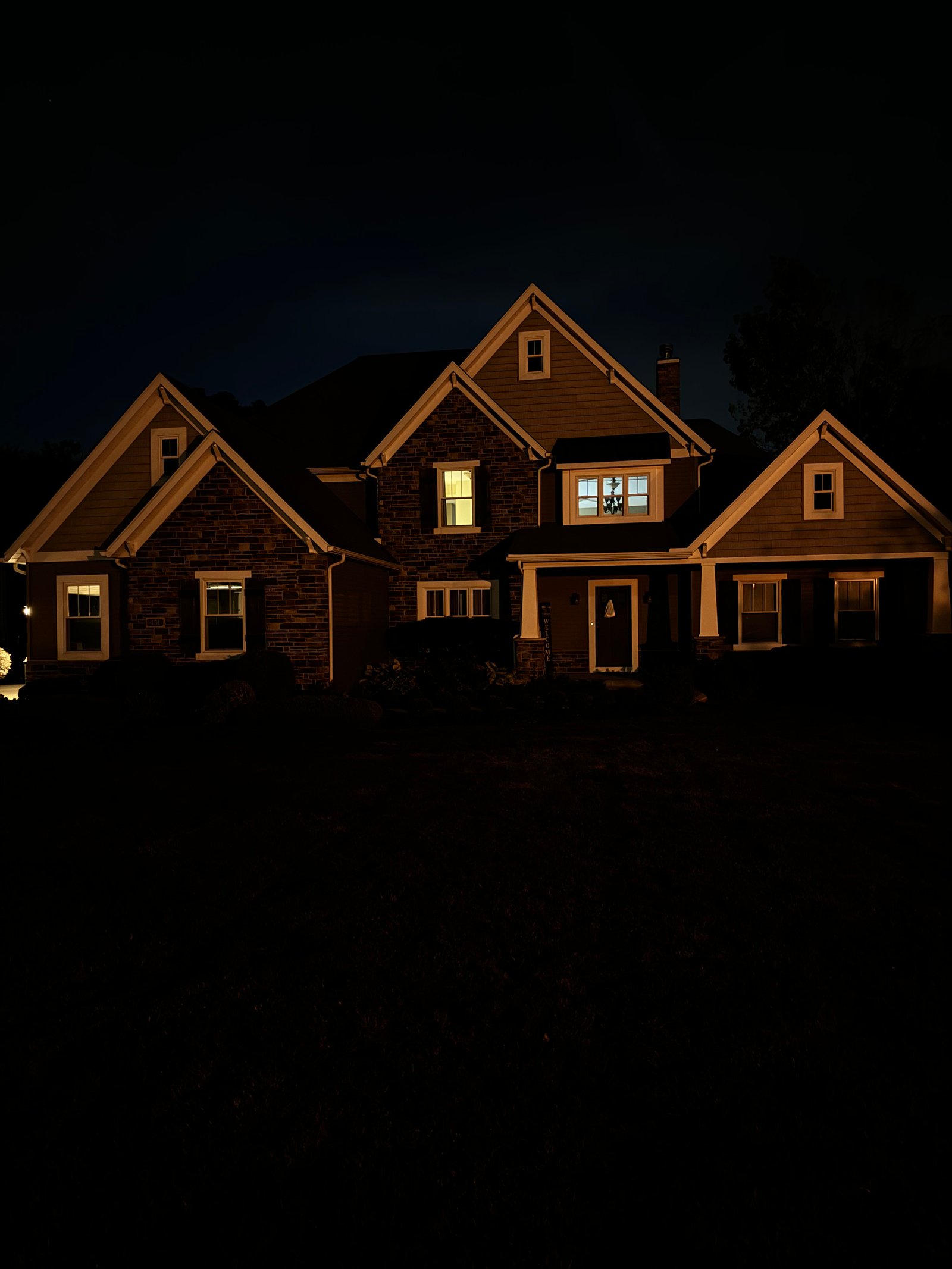 Home exterior at night before architectural lighting